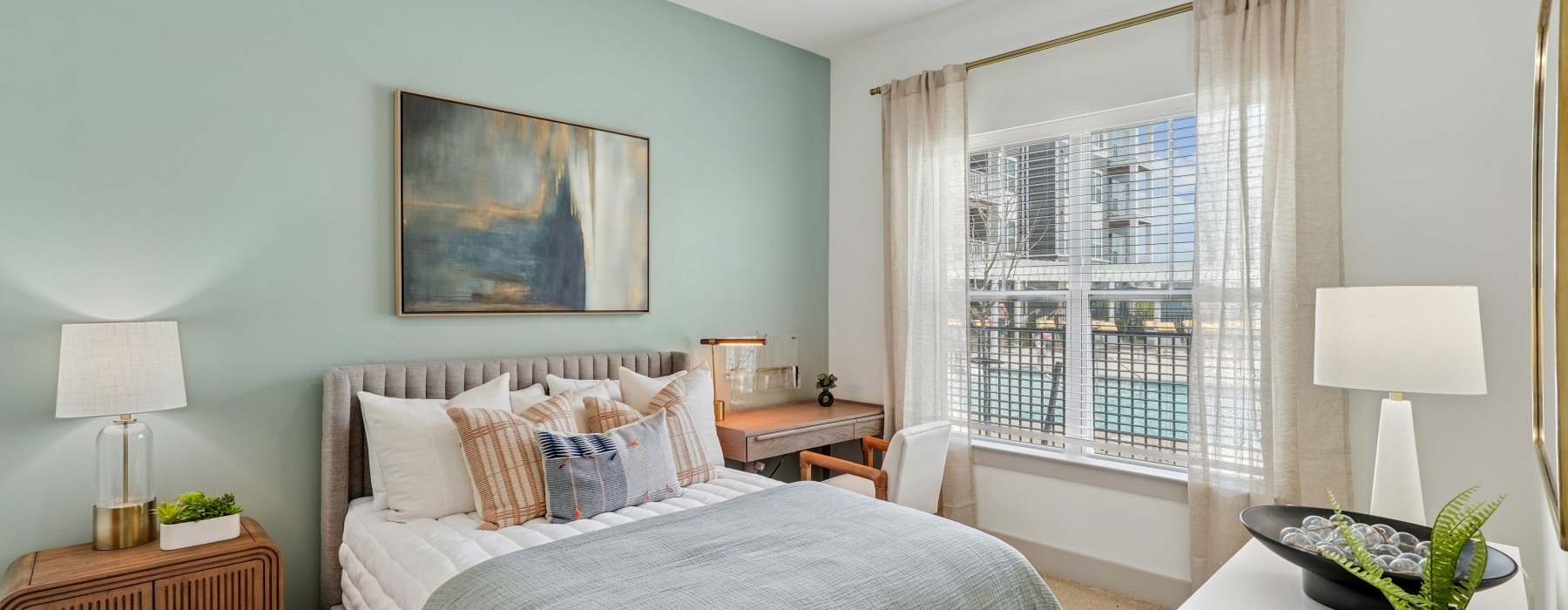 Bedroom with bed, decor, and view of the pool